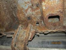 Third from front picture showing cab bottom and running board hangars. This part seems pretty solid, except for the obvious rocker panel repair.