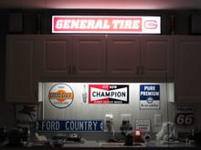 Detail of the signs, storage and lighting that's over my garage work bench.