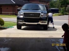 washing her so she can be clean , and daddy's little helper overseeing the progress