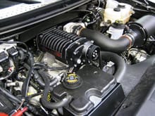This shows the old setup with the reservoir mounted over the radiator and the hard to service air box.