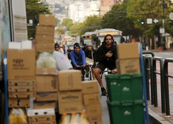 Bicycle riders contend with a package-blocked bicycle lane in San Francisco in 2015. Robert Galbraith/Reuters