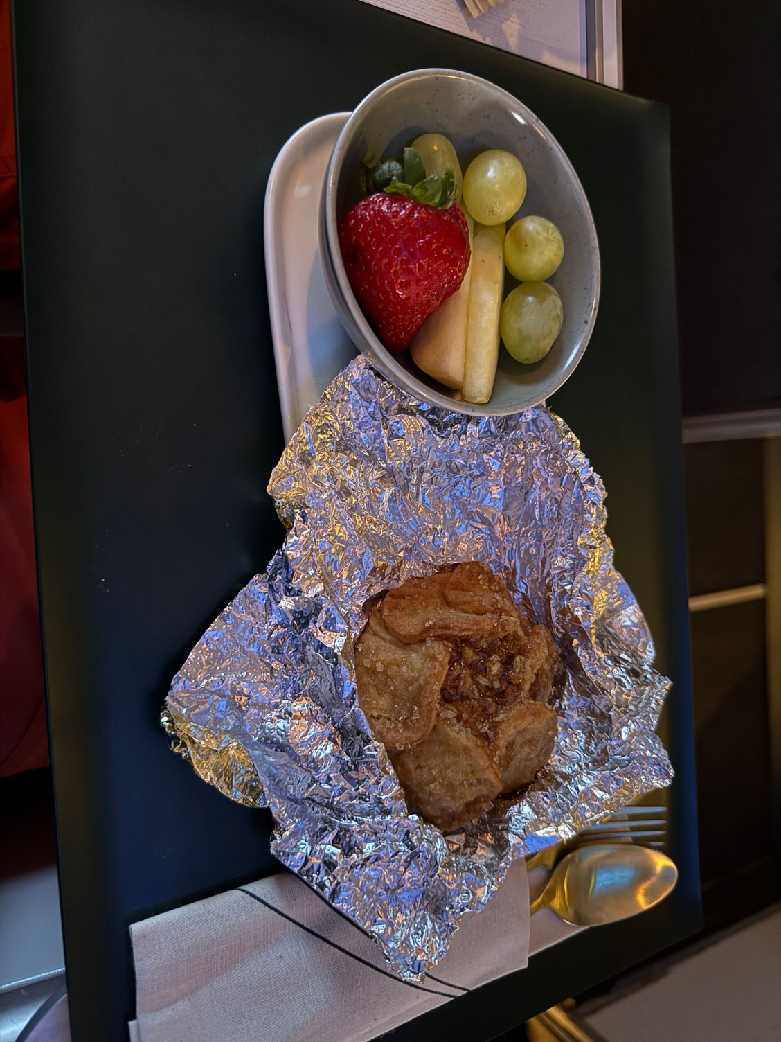 Breakfast pastry with fresh fruit. Warm cinnamon-apple pastry with a small side of fruit. Pastry was good, fruit was fine just a very small quantity.