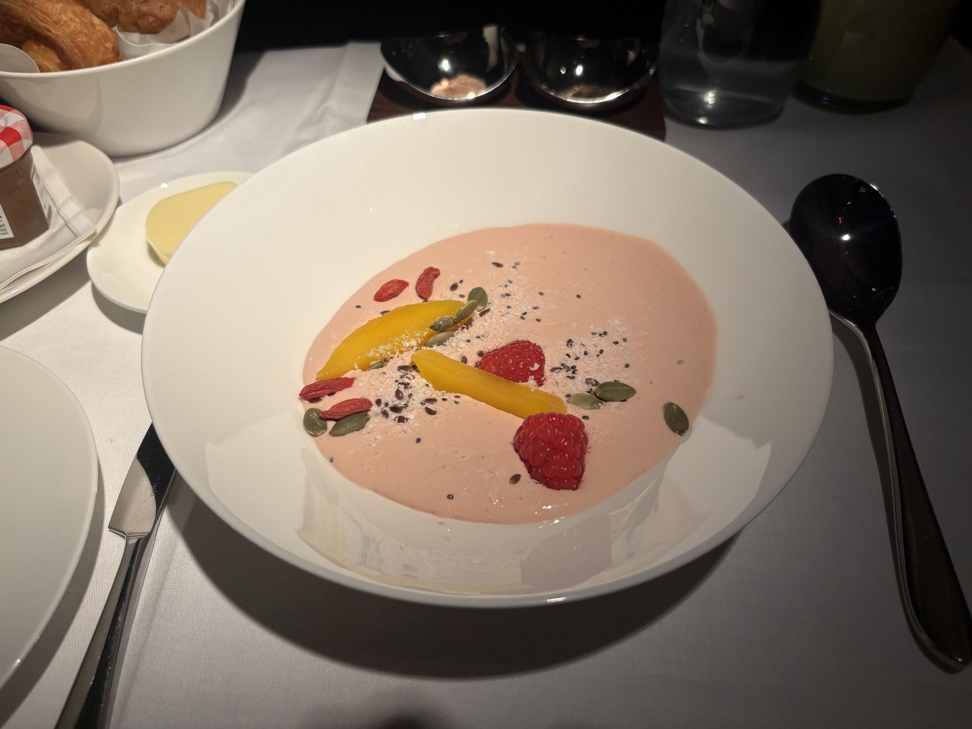 Raspberry yoghurt bowl with seasonal fresh fruit and mixed seeds