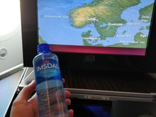 Norvegian mineral water bottle (actually a bit too tall to fit inside the armrest storage...)