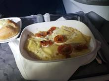 Black Truffle Ravioli Gratin with creamy parmesan sauce, truffle bread crumb crust and fresh herb cherry tomatoes
