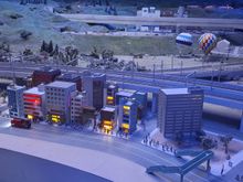 Near the Tokyo section, the balloons rose during the day and at intervals you heard a faint fire alarm. You can see  simulated flames and smoke from the building in the foreground and the ambulance and fire engine come from round the back of the block. Very impressive
