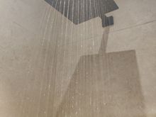 Water pressure is low but ok for the rain shower. Gravity helps.