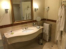 Bathroom - sink area with towel rack and bathrobes