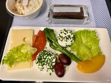 Goats cheese with chives, emmental, tenderstem broccoli, grapes, salad, orange