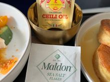 The salt is now in a cheap paper packet instead of the little metal tin