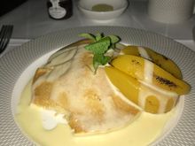 Pancakes with warm peach slices and vanilla anglaise