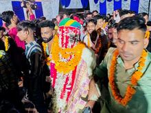 The groom arrives finally on Day 3 of the wedding. He is veiled as he enters with flowers. 
