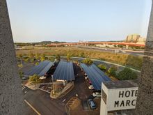 View from NE facing corner, to larger parking lot with solar panel bays and EV charging