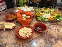 Roasted cherry tomato bruschetta on home made garlic crostini, baguette and crackers, Boursin cheese and jam, fruit and veggie tray with hummus, various cheeses 