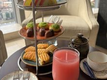 Paninis, sweets, sliced fruits, juice and coffee/tea