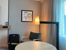 Room has a table and comfy chair but no ergonomical desk area