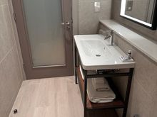 Bathroom is a long layout that has doors into the bedroom and into the bedroom.