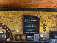 Historic WW2 signatures on the ceiling and modern signatures on the wall at The Eagle