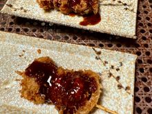Appetiser of breaded pork and onions