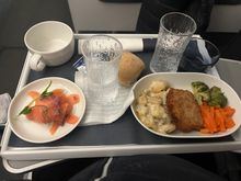 My flight to London was cancelled so got flight to Edinburgh with Norra and my first E90 flight. Very uniqie stuert serving on flight. Then excellent BA flight to London. 
Salmon for starter and chicken for main