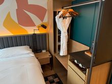 Open closet and luggage space that's a bit hard to get to