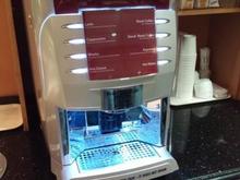 There are tea packets on the right behind the machine