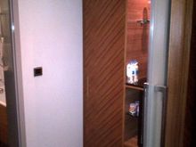 Changing area, with closet and minibar between bedroom and bath