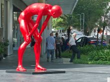 Caight wiping his shoe on the grass