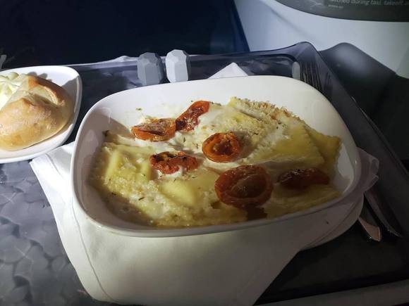 Black Truffle Ravioli Gratin with creamy parmesan sauce, truffle bread crumb crust and fresh herb cherry tomatoes
