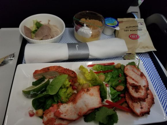Chicken tikka with yogurt, salad, and pomegranate seeds. The small dish tasted of a tuna pate. Lemon something with graham crumble topping. Roasted peeled almonds in the bag.