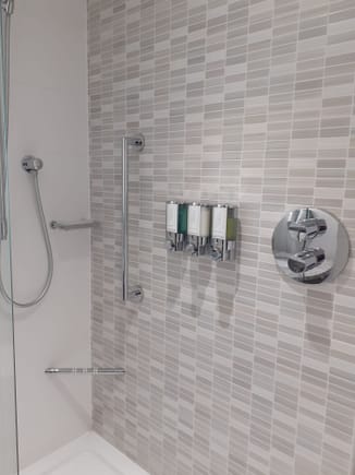 Wall mounted dispensers. As with the room, everything was spotless. Bathroom was well lit. 
