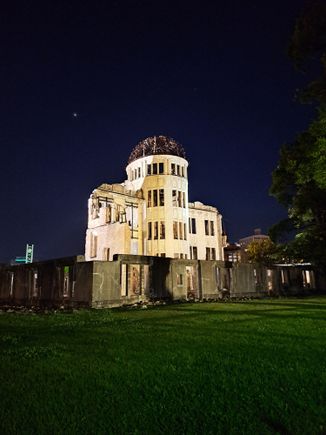 The A-dome building ( and peace clock to the left) at night