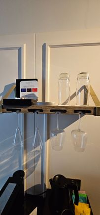 Shelf with hanging glassware and Nespresso type pods