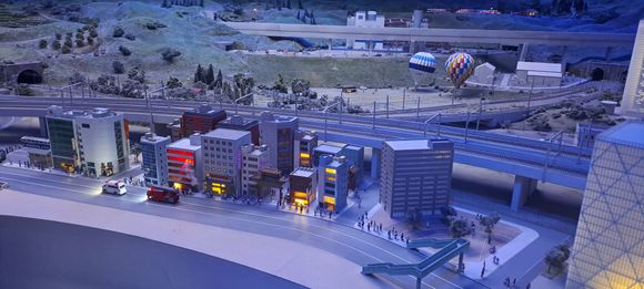 Near the Tokyo section, the balloons rose during the day and at intervals you heard a faint fire alarm. You can see  simulated flames and smoke from the building in the foreground and the ambulance and fire engine come from round the back of the block. Very impressive
