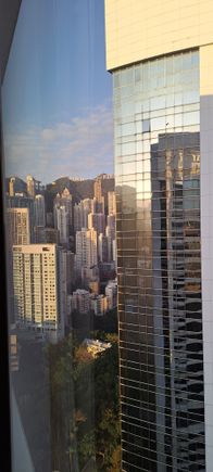 By getting close to the window and looking left , you can just make out most of the peak tower  just to the left of the edge of the shangri la ( later on I would see a few window cleaners at work )