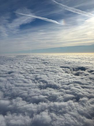 Above the clouds at Flight Level 60 (around 6000 feet), heading  198 degrees with a ground speed of 220 knots.
