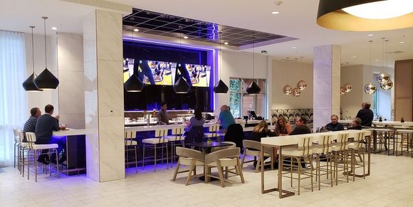 Bar and restaurant area with breakfast to the right side beyond