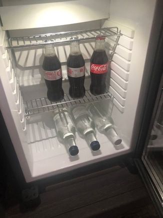 Mini fridge in room with free drinks