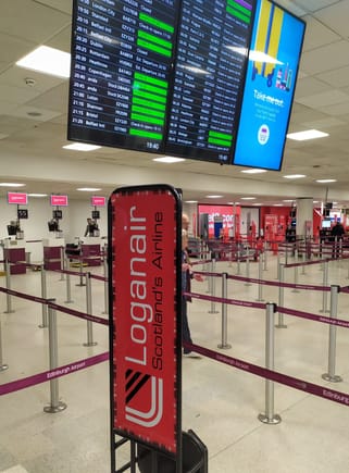 Loganair check-in area in Edinburgh airport (EDI): Loganair is one of the few airlines whose logo has not changed since the early years, when I was little 