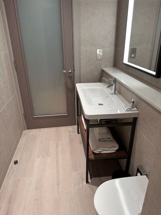 Bathroom is a long layout that has doors into the bedroom and into the bedroom.