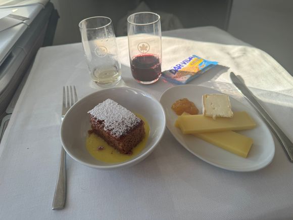Hazelnut cake with vanilla sauce and the cheese plate. Personally loved the cake it had a moist sticky toffee pudding like consistency and a really nice hazelnut and vanilla flavour way better than my outbound Jan 31 YUL-LHR cake dessert of that I forget the name. The cheese plate was missing a the cheddar and doubled up on Bergkäse but wasn’t bad.