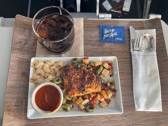 AS 1092 SEA-LAX 4 PM lunch. Someone else will need to supply the AS description. Chicken (?), white beans and salad made mostly of sliced olives. Surprisingly tasty. The sauce helped a lot. Warm chocolate chip cookie for dessert. No snack basket offered. Service from the F FA was very good and attentive throughout the flight.