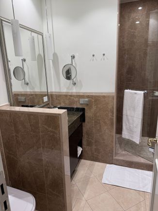 The bathroom is away from.the bedroom which is good in the night to not disturb so,eine sleeping with turning on the lights. Water pressure was fine. Toiletries are all from L’Occitaine. 