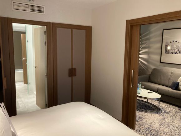 View from bed into living room and bedroom's closets