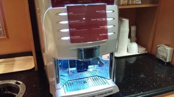 There are tea packets on the right behind the machine
