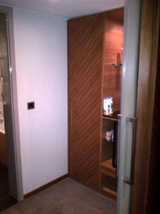 Changing area, with closet and minibar between bedroom and bath