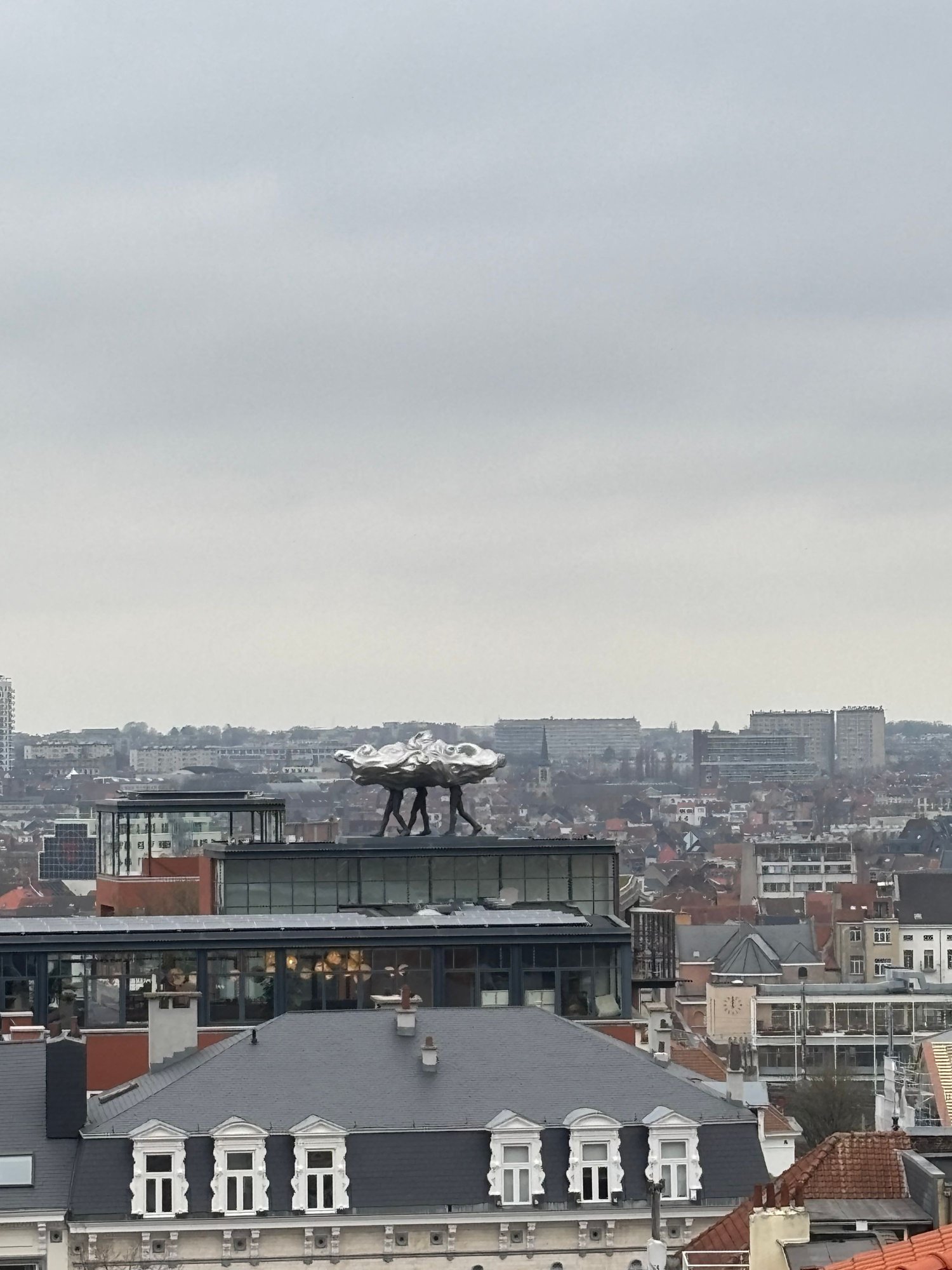 View from Place Poelaert, overlooking the lower town.  What looks like three men carrying a chrome cloud is actually an artwork.