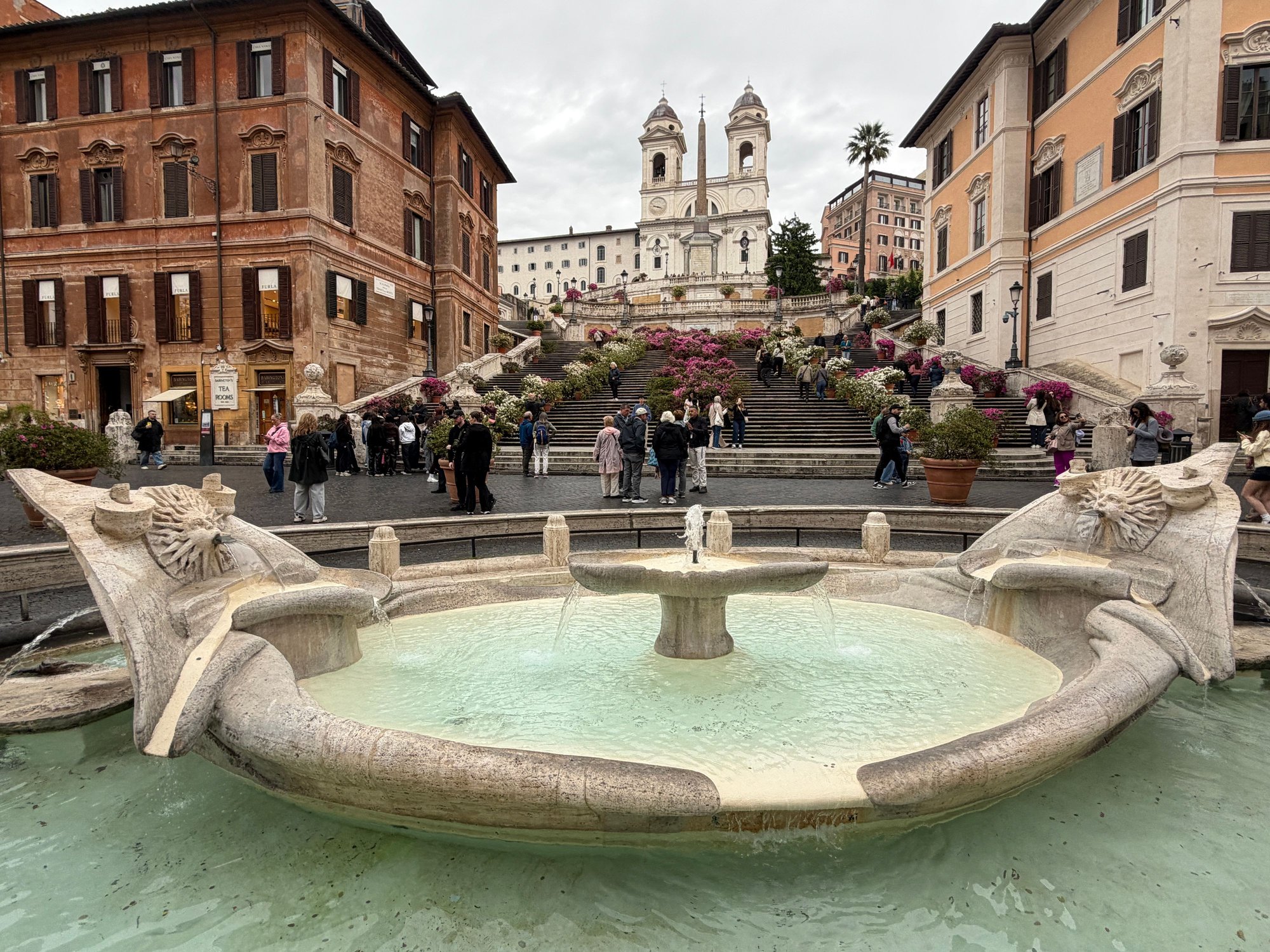 Spanish steps with the church at the background and the Fontana della Barcaccia at the foreground
