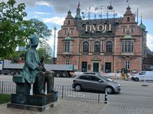 The famous bronze statue of the Danish fairy tale author Hans Christian Andersen, just outside the Radhus gazing at the Tivoli Gardens