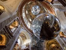 Interior of Karlskirche with sphere art installation and elevator